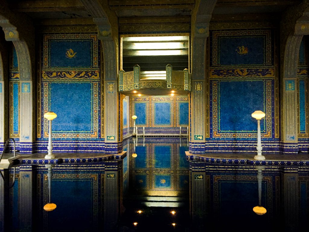 an indoor swimming pool with tiled walls