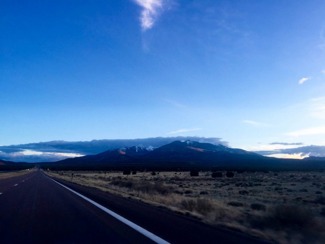 road trip photos always feature the open road. here's the road next to a mountain