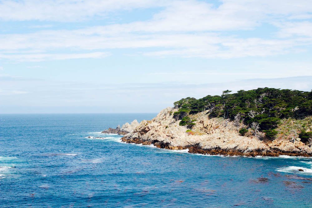a rocky cliff jutting out into the ocean