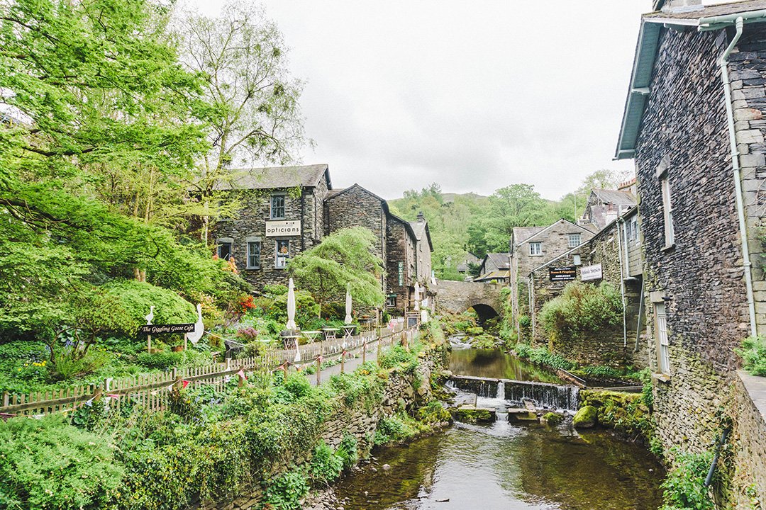 The river running through Ambleside in the Lake District, UK, with stone houses lining the shore