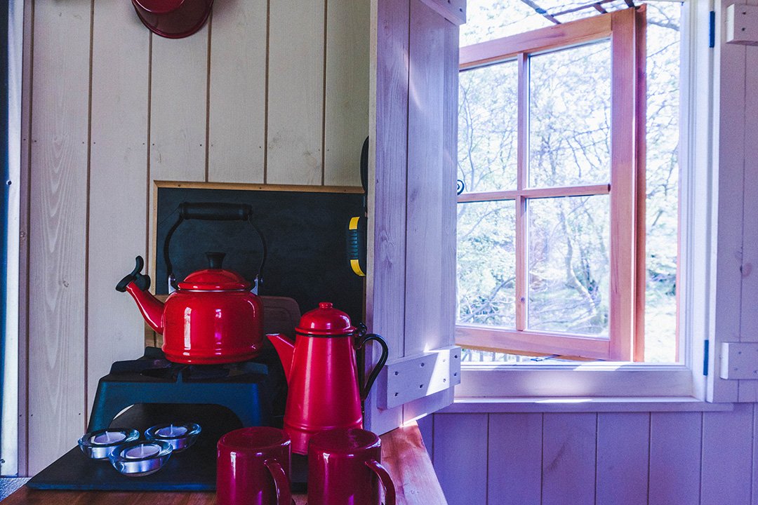 Red kettle on the stove of the Herdy Huts, Lake District glamping