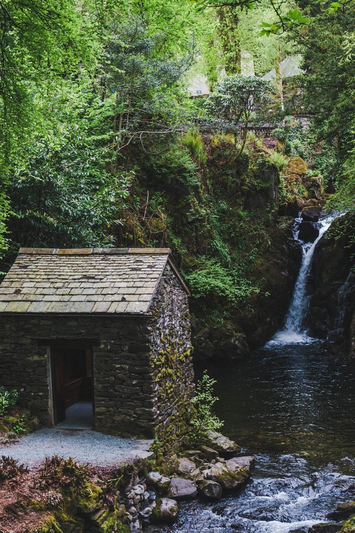 a small house set near a waterfall in the Lake District