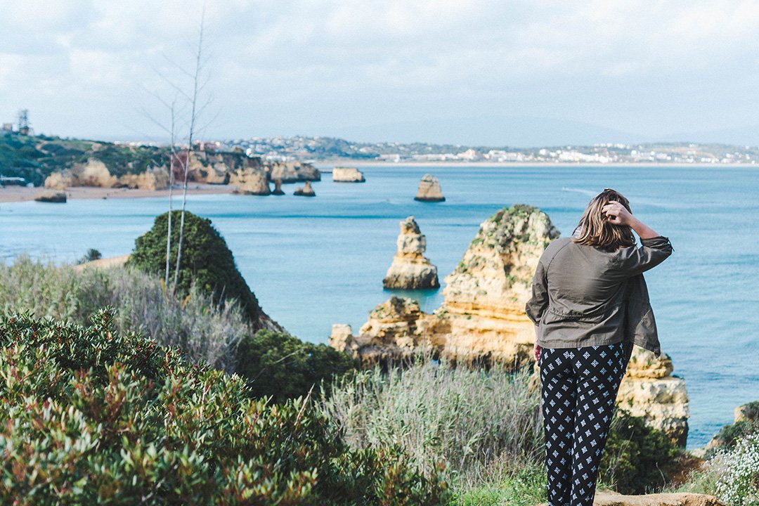Madison staring out at the cliffs of Lagos, Portugal