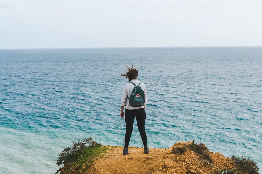 Addie staring into the distance on a hike in Lagos, Portugal