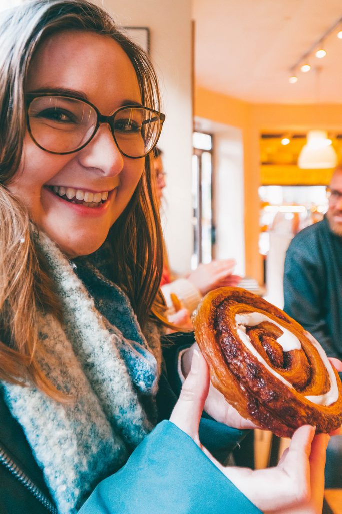 Addie with a chocolate snail pastry at a bakery on our hygge tour Copenhagen