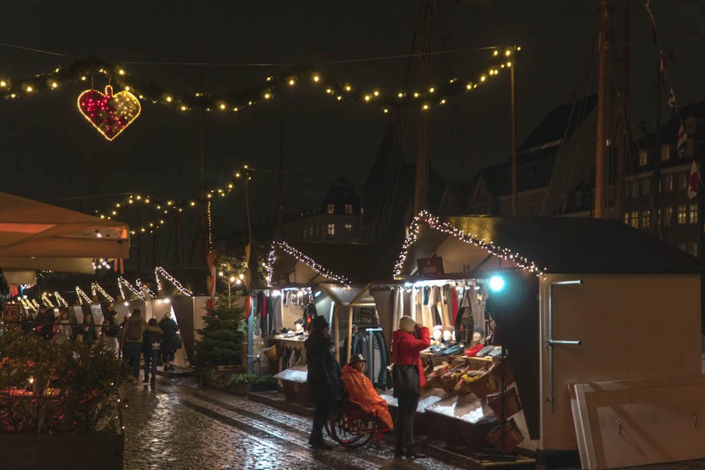 Nyhavn Christmas market at night, all lit up.