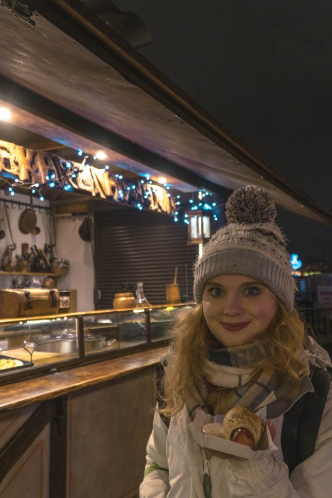 Megan holding a sausage at the Nyhavn Christmas Market
