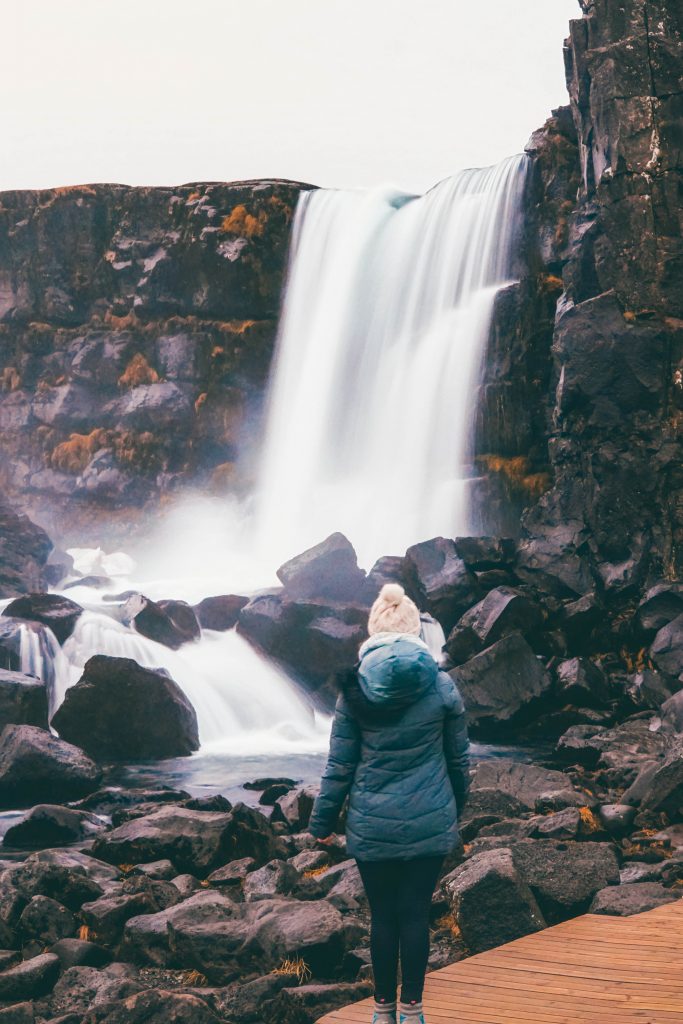 Addie gazing at a waterfall in Pingvellir National Park, Iceland