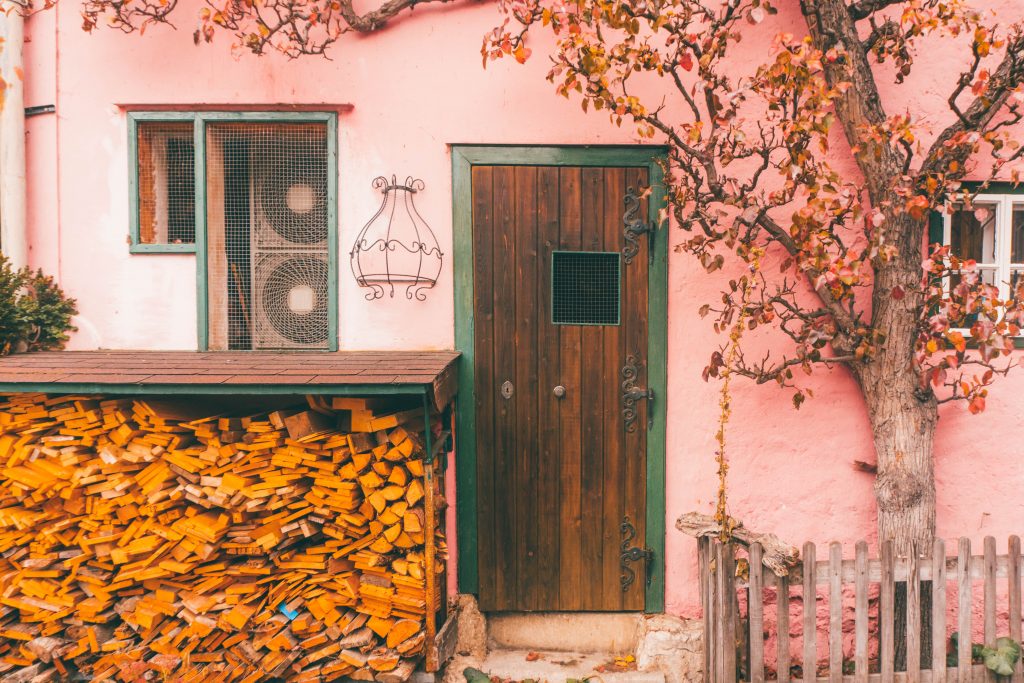 A pink house with a firewood store in Hallstatt, Austria