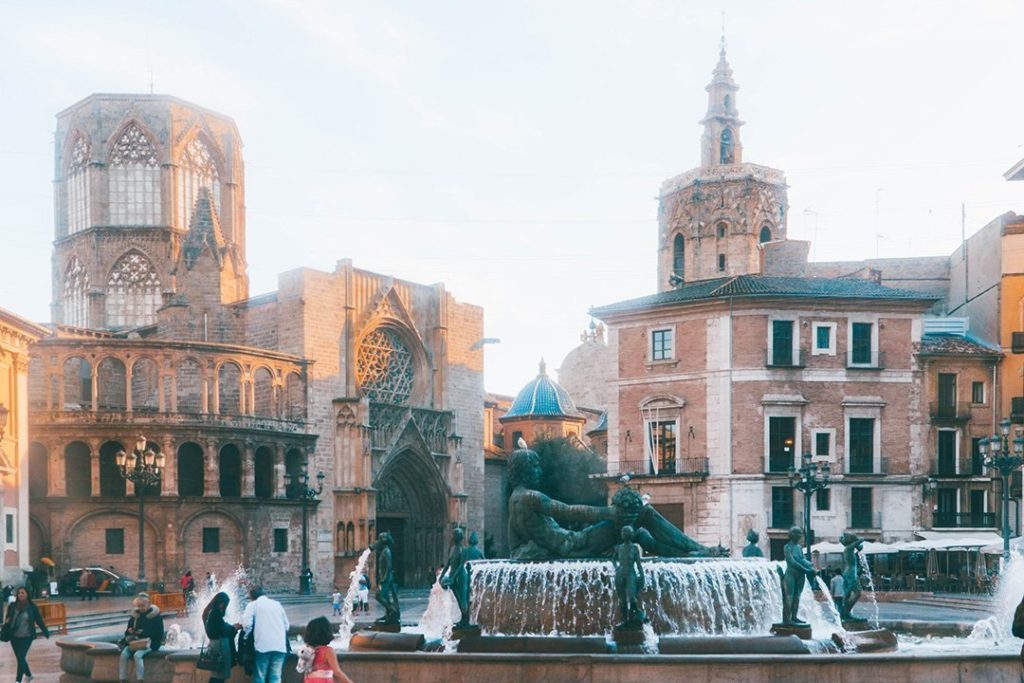 A bustling square at sunset in the old town of Valencia