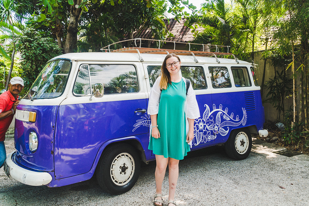 Addie in front of a purple VW Kombi