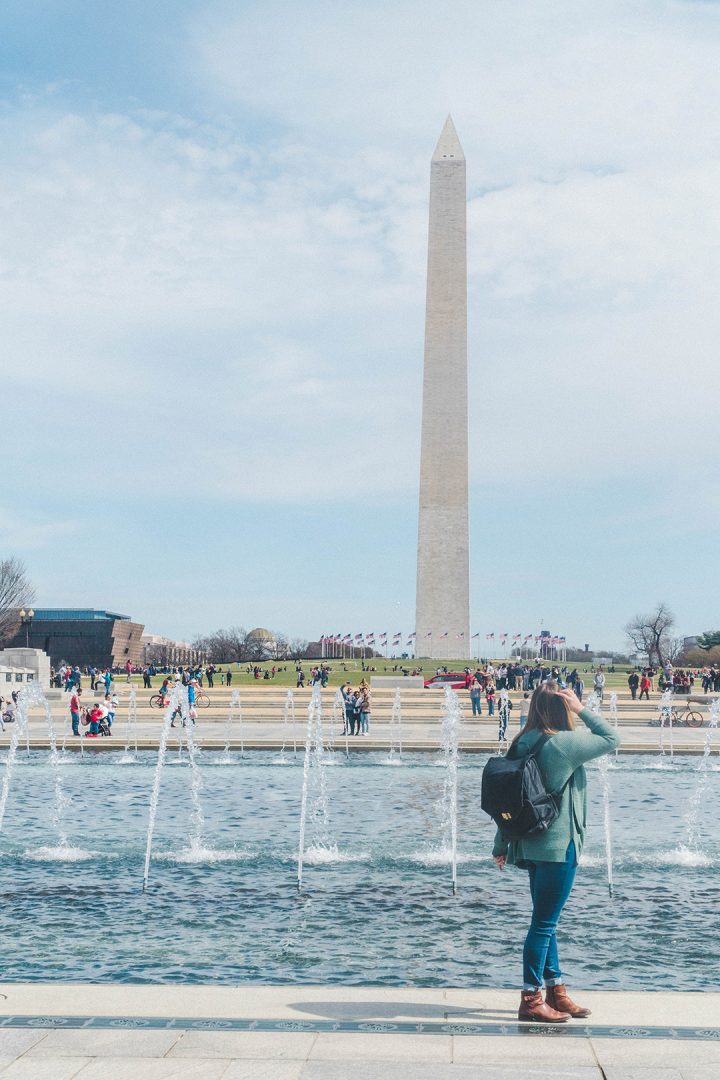 Addie looking back at the Washington Monument while in the plaza of the WWII Memorial on the National Mall
