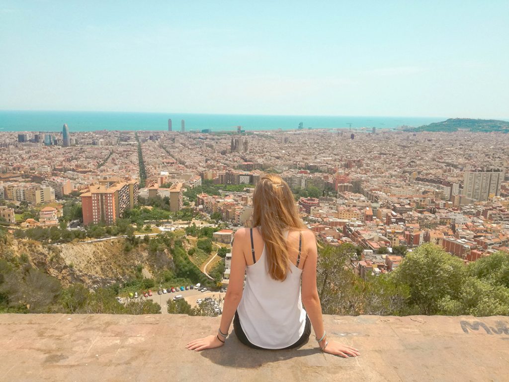 A girl looking out at a birds-eye view of Barcelona, Spain