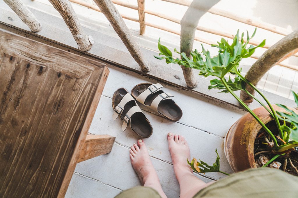 Addie kicking off her birkenstocks on the terrace