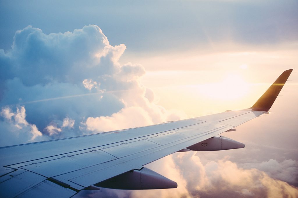 An airplane wing in the clouds