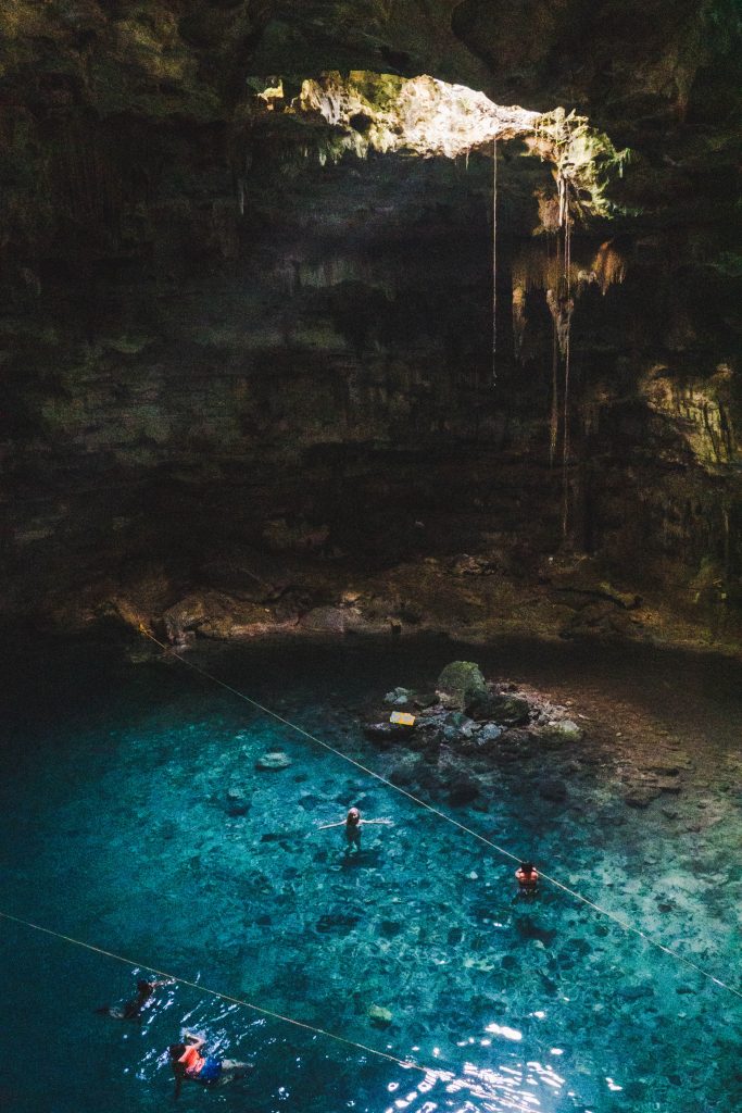 blue water at cenote samula, a lake inside a cave