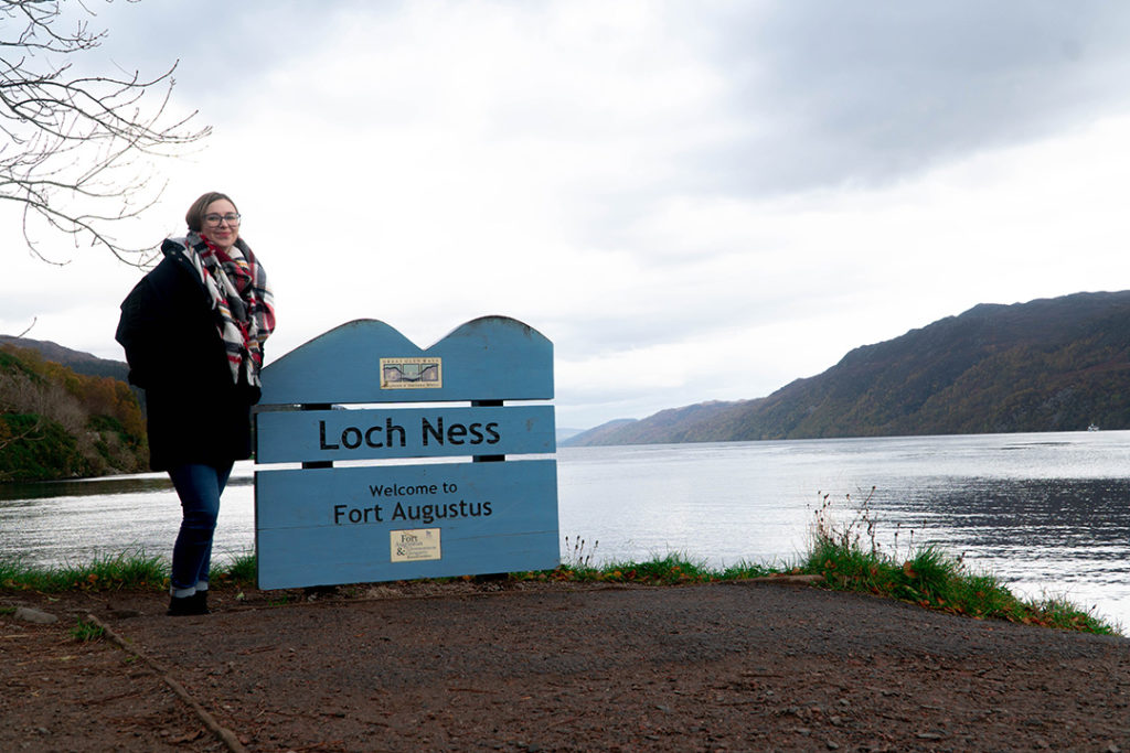 addie standing by the loch ness sign, a stop on the Rabbie's Isle of Skye tour from Edinburgh