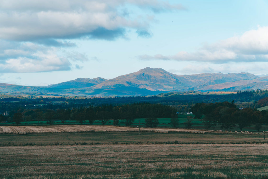 A view across a field to mountains in the background