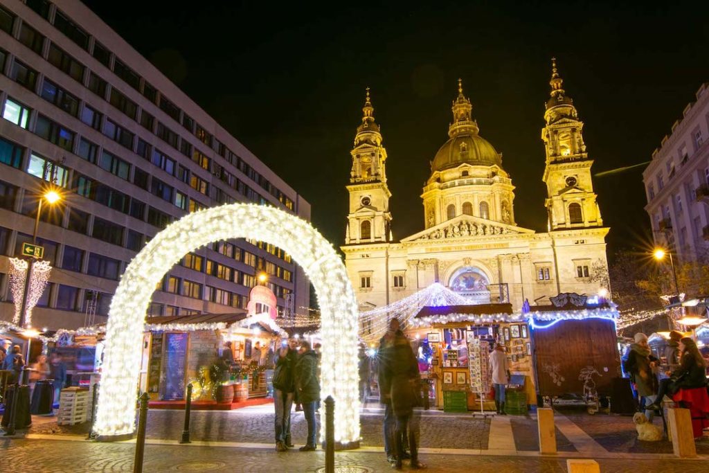 a christmas market lit up at night in Budapest, Hungary - one of the best places to visit in Europe in winter