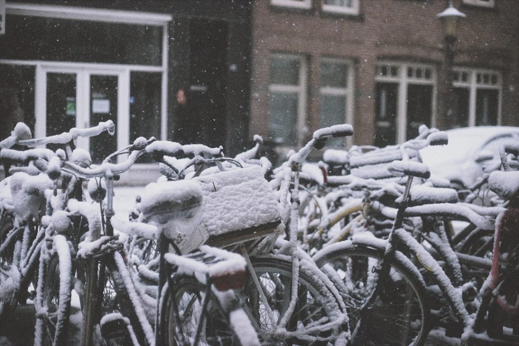 bikes covered in snow in Amsterdam, the Netherlands - one of the best places to visit in Europe in winter