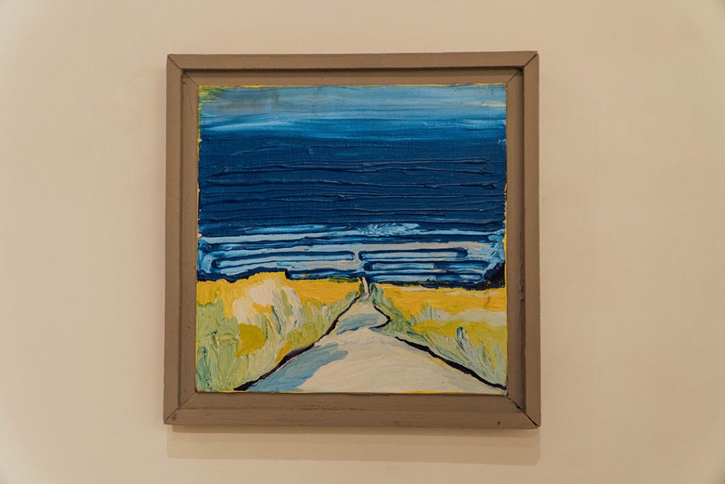 an oil painting with blue sky and a road through the wheat