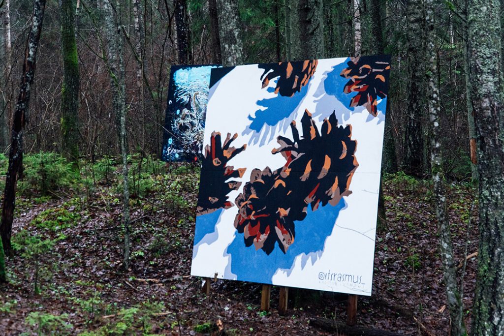 a large painting of pine cones in the woods