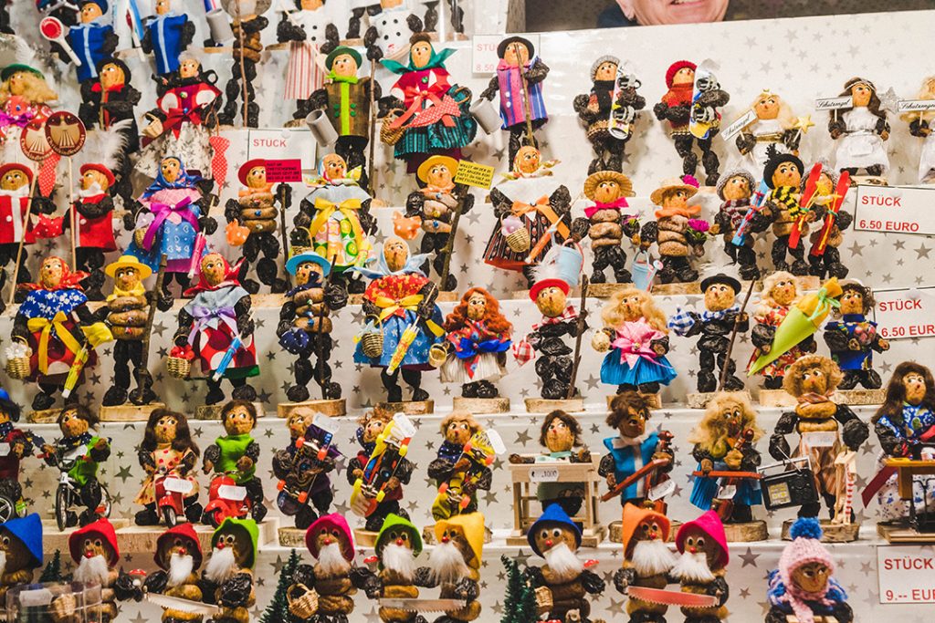 many shelves full of small dolls made out of prunes and walnuts