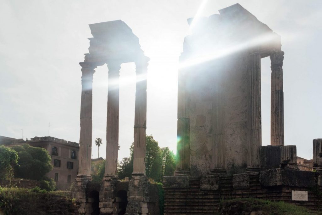 sun rays shining through columns at the Roman Forum