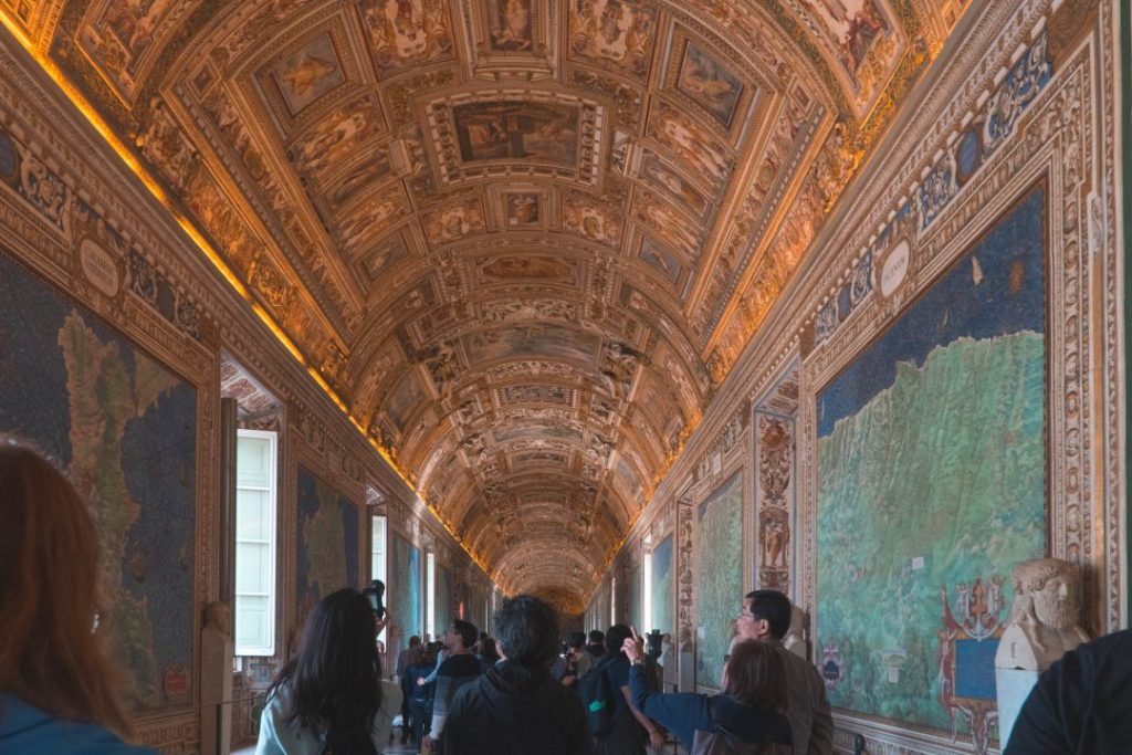 many people in the gilded hallway of the vatican museum in rome - one of the biggest rome travel mistakes you can make is thinking that there will ever NOT be crowds!
