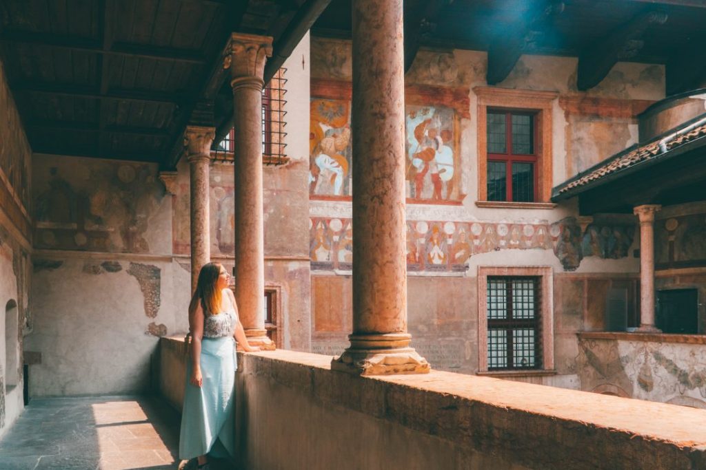 Addie standing on the balcony of a castle in Trento, Italy