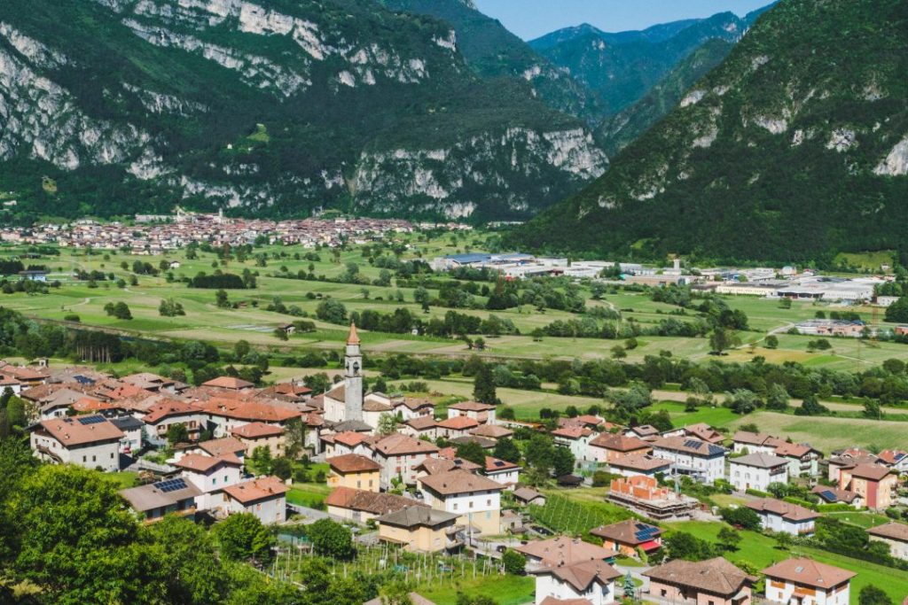 A small, red-roofed town in a valley in Italy