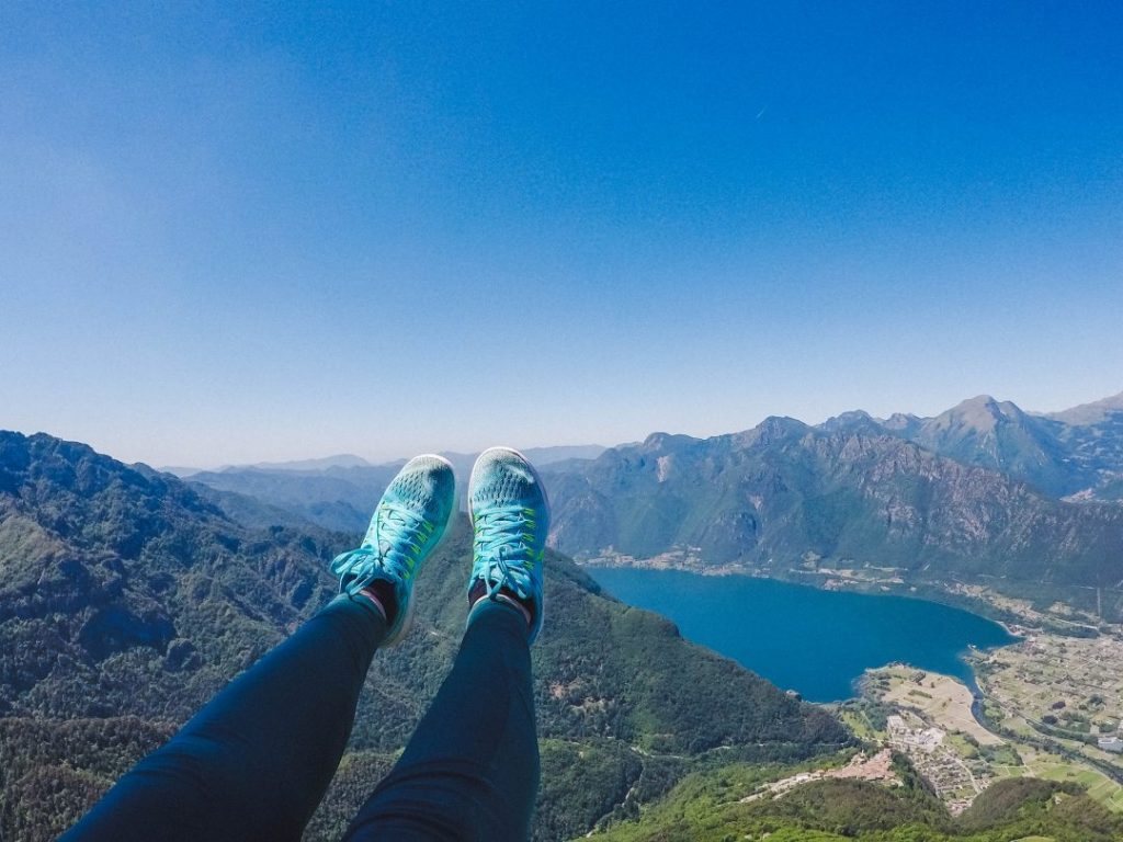 Addie's feet in the air, flying over Lake Idro