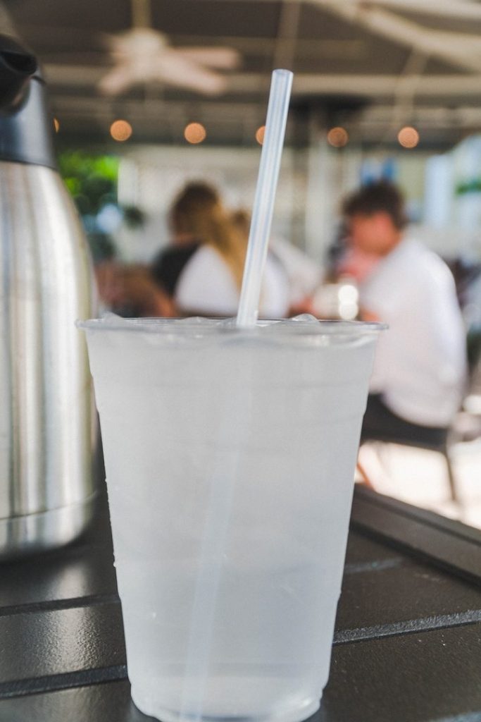 a plastic cup with a plastic straw