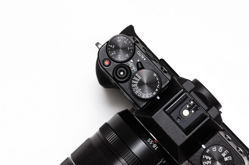 a camera with many dials for shooting in manual mode, photo taken from above