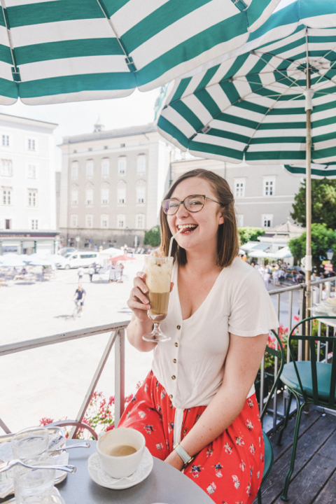 addie sipping an eiscafe on a cafe terrace with perfect exposure