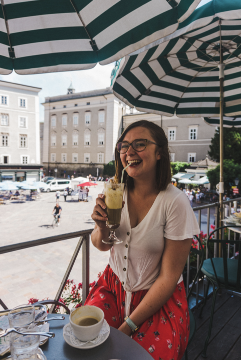 and under exposed picture of addie sipping an eiscafe on a cafe terrace