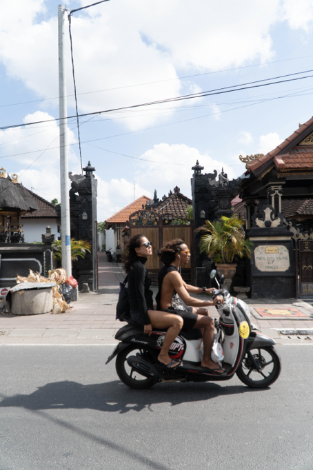 a picture of a motorbike on a road in bali with a short shutter speed exposure