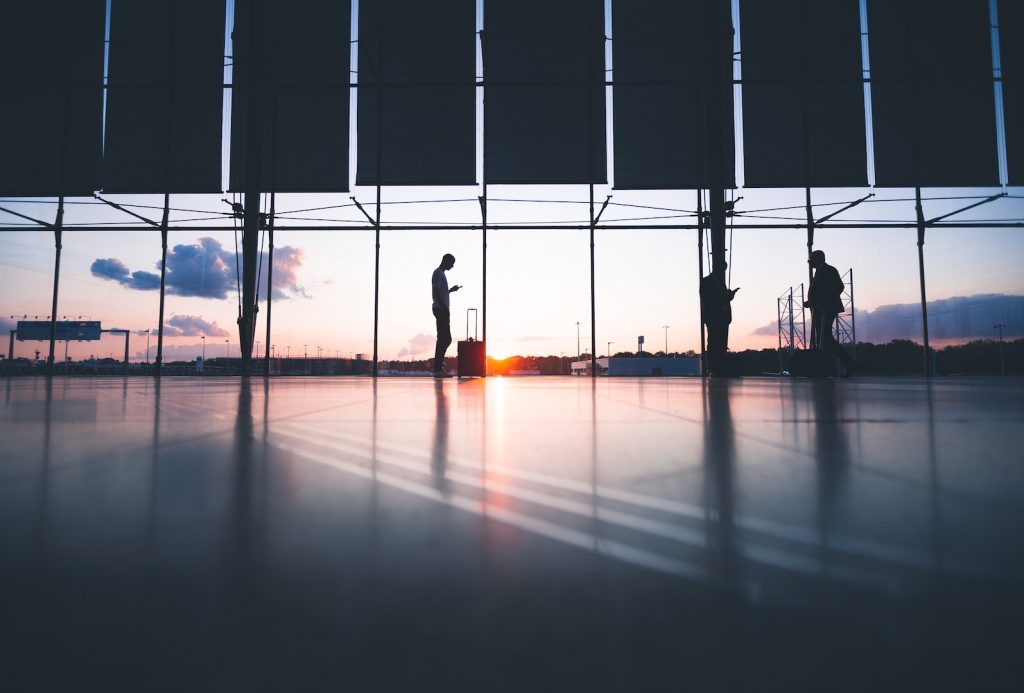 silhouettes in an airport at sunset