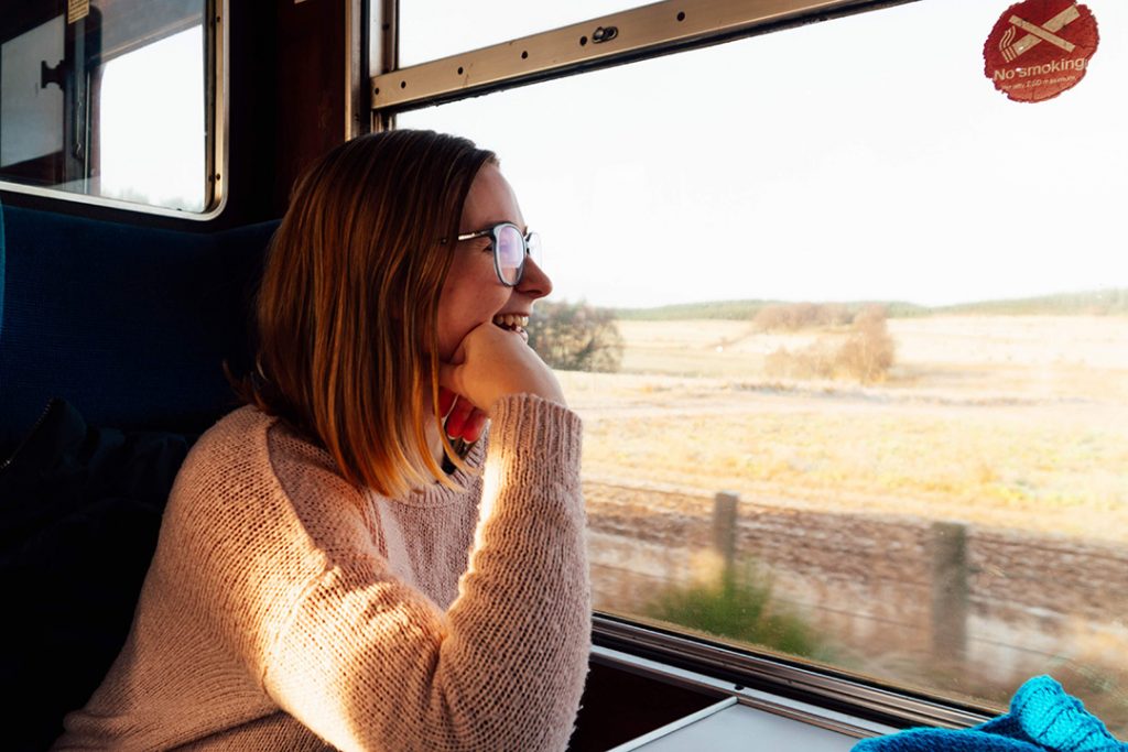 addie looking out the window of the strathspey railway - one of the best things to do in aviemore