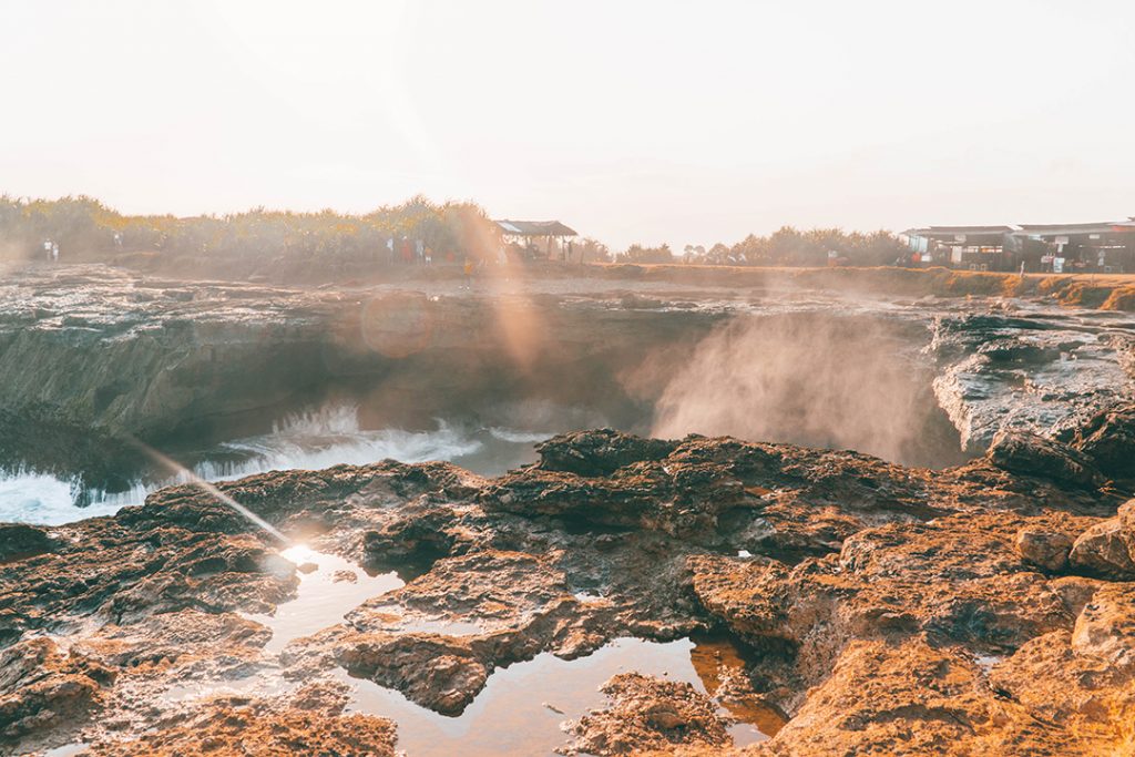 mist coming up from devil's tear on nusa lembongan. Read this Nusa Islands guide for the best things to do!