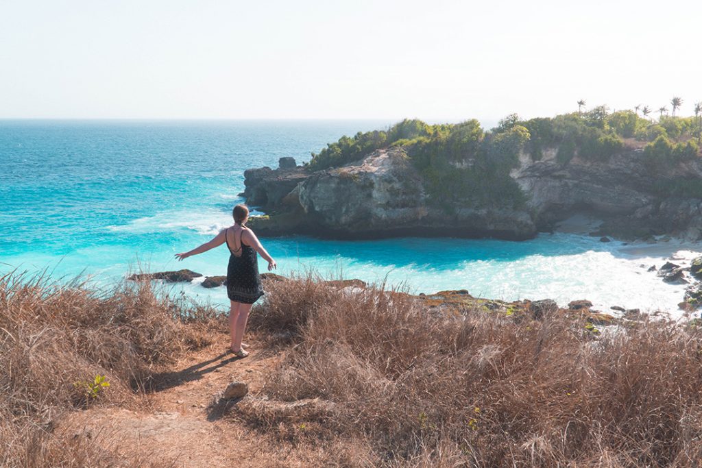 addie standing in front of blue lagoon on nusa ceningan