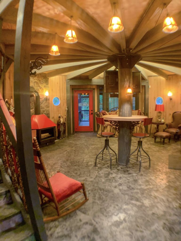 inside the hobbit house, with whimsical furniture in a round room