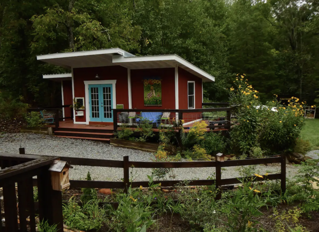 a red tiny house with turquoise doors